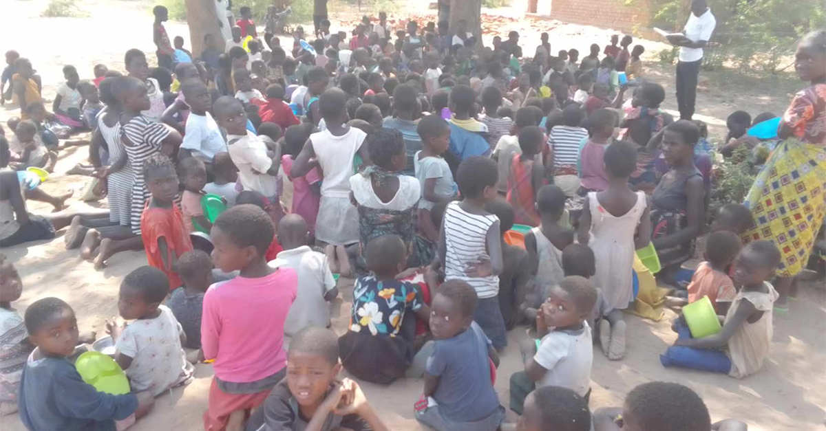 A large group of children in Malawi suffering from a hunger crisis.